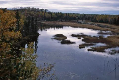 Overcast Fall sky reflected in the lake. Panoramic view Stock Photos