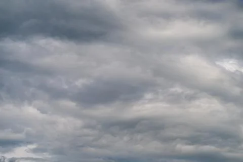 Overcast gray clouds indicate approaching storm. Dense layer of dark grey clo Stock Photos