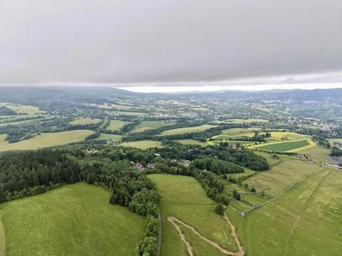 Overcast rolling countryside with patchwork fields and winding tracks Stock-Fotos