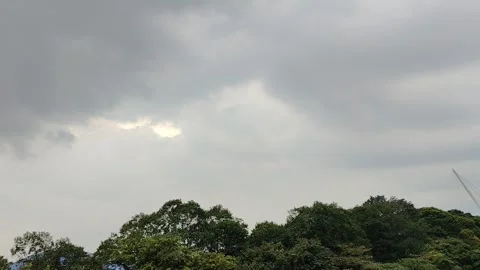 Overcast sky with a break in the clouds revealing sunlight Stock Footage 319055309
