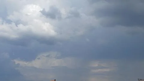 Overcast sky, dark clouds, heavy weather, building silhouettes, urban sky 스톡 사진