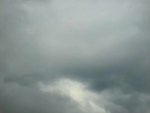Overcast sky with dense gray clouds signaling an impending storm. Stock Photos