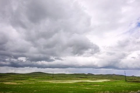 Overcast sky with dramatic clouds above grassy plains Stock Photos