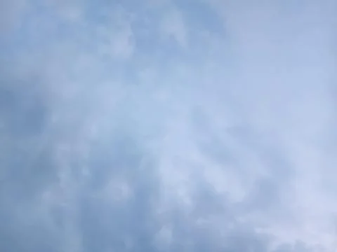 Overcast sky filled with dense pale blue and grey clouds Stock Photos