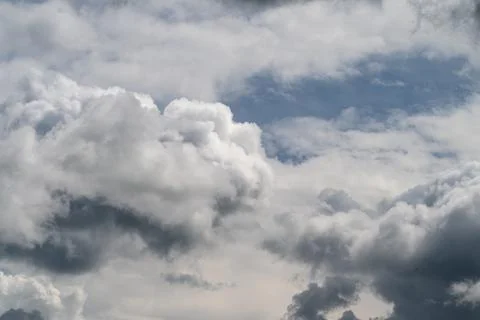Overcast sky with fluffy clouds spreading calmness. Tranquil scene of subdued Stock Photos