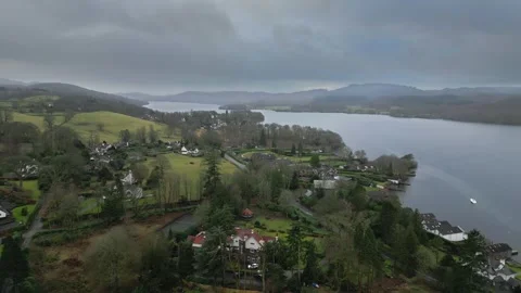 Overcast sky looms above quiet lakeside village Stock Footage 345653380
