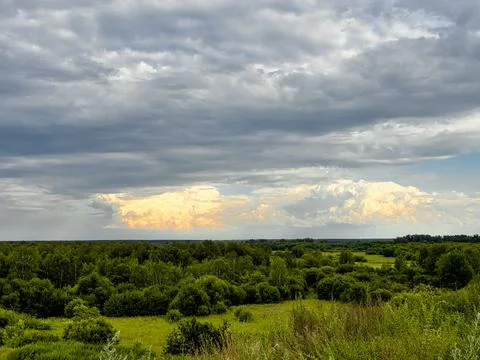 Overcast sky with many clouds. Summer landscape at sunset. Stock Photos