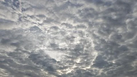Overcast Sky with Sun Rays Peeking Through Clouds Stock Photos