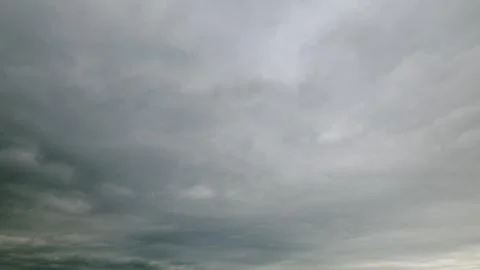An overcast sky with swirling clouds that evoke feelings of drama and tranquilit Stock Photos