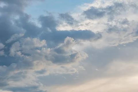 Overcast sky with various cloud formations, ranging from fluffy to dense, hin Stock Photos