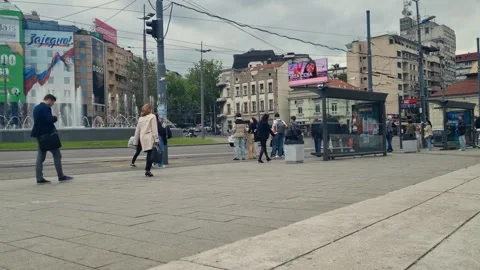 Overcast spring day in central Belgrade: people wait at a bus stop near Slavija 스톡 동영상 316133562