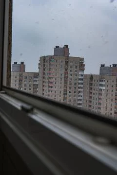Overcast window view of Soviet era panel blocks with balconies Stock Photos