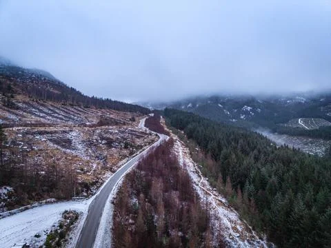 Overcast winter road through remote mountain landscape in southern Norway Fotos de archivo