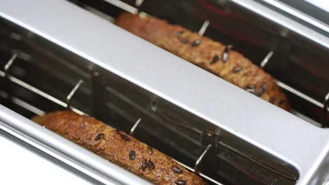 Overcooked and burnt toast bread popping up from white toaster machine 動画素材 87815049