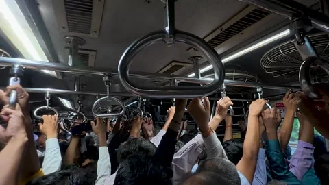 Overcrowded train full of commuters holding on handles Vídeo Stock 342129398
