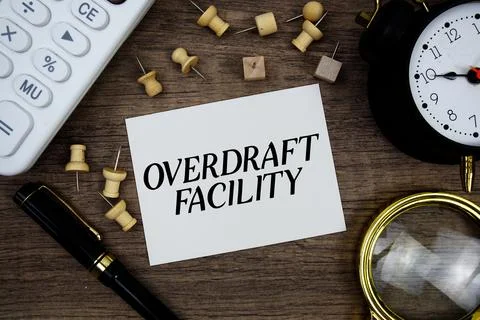 Overdraft Facility text written on notepad with pen, alarm clock, magnifyin.. Stock Photos