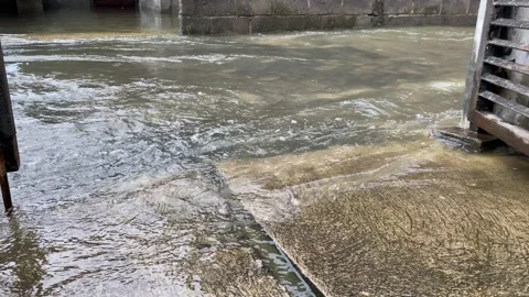 Overflow water from river, next to the building or house Stock Footage 294850435