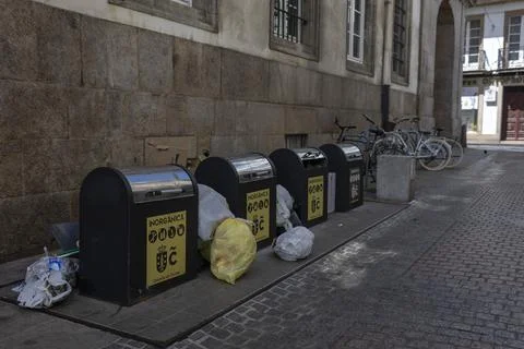 Overflowing garbage cans in the city center. Stock Photos