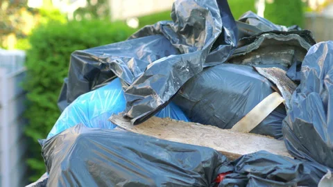 Overflowing garbage container on the street in 4k slow motion 60fps Stock Footage 233264853