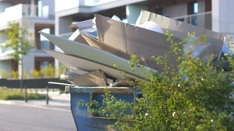 Overflowing garbage container on the street in 4k slow motion 60fps Stock Footage 233265590