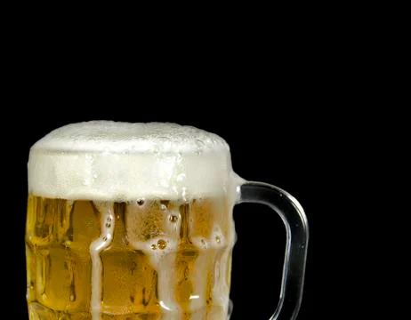 Overflowing mug of beer Stock Photos