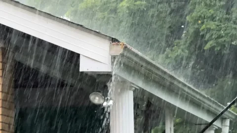 Overflowing Rain Gutter on House Stock Footage 312075425