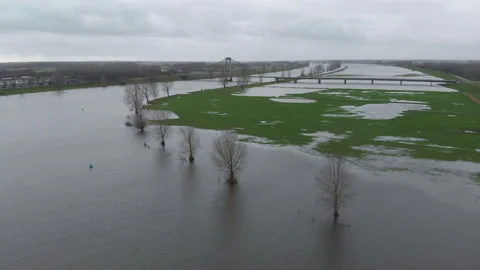 Overflowing river in the Netherlands during high tides with land under water Stock Footage 259849897