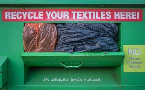 Overflowing Textile Recycling Bin 库存照片