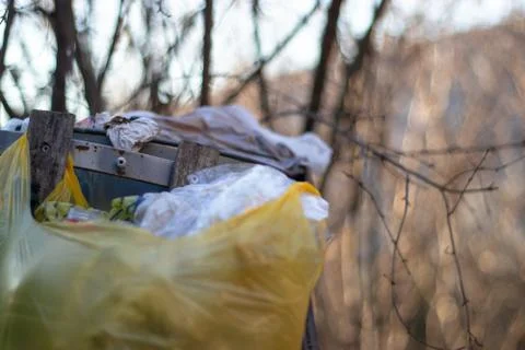 Overflowing trash bin with multiple trash bags Stock Photos