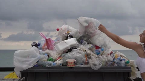 https://images.pond5.com/overflowing-trash-can-girl-puts-footage-160036329_iconl.jpeg