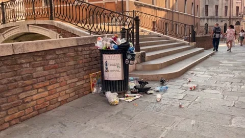 Overflowing trash can in a square in venice Stock Footage 218260936