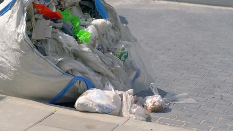 Overflowing trash container in 4k slow motion 60fps Stock Footage 155787190