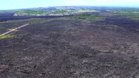 Overflying Acres of Solid Volcanic Lava Stock Footage 130359163