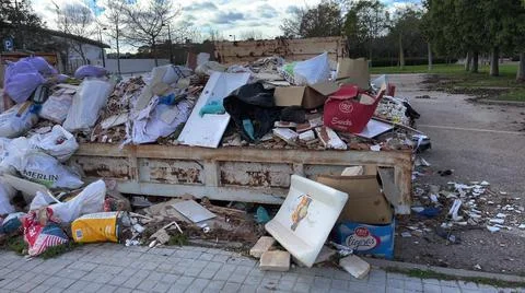 Overfull container with constructions debris Stock Photos