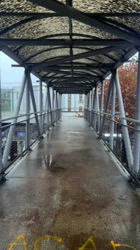 Overground pedestrian crossing. Old rusty metal corridor with dirty roof Stock Footage 293626771