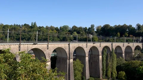 Overground train passing over a railway bridge in Luxembourg Stock Footage 127944620