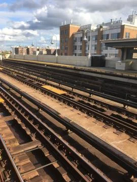 Overground train tracks at an empty subway platform in Queens, NY Stock Photos