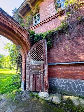 Overgrown Archway of an Abandoned Red Brick Estate Stock Photos