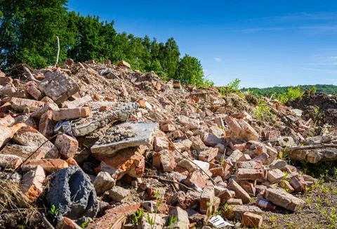 Overgrown Ruins of a Brick Structure Under a Blue Sky Stock Photos