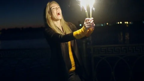 Overhappy woman with two roman candles in her hands moving in slow-motion Stock Footage