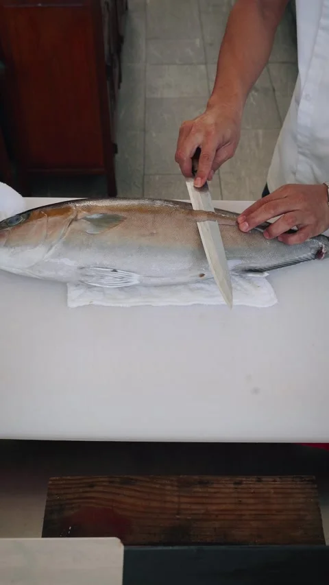 Overhead 4K kitchen counter video chef cutting bluefin tuna skin Stock Footage 317519155