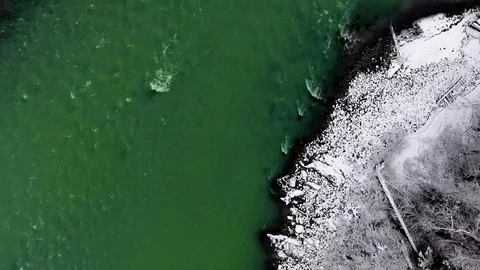 Overhead aerial camera captures the flow of the river and the coast with pines Video stock 119237289