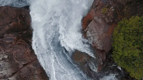 Overhead aerial camera captures a waterfall and rocky shores. Aguasabon Falls Stock-Footage 126077855