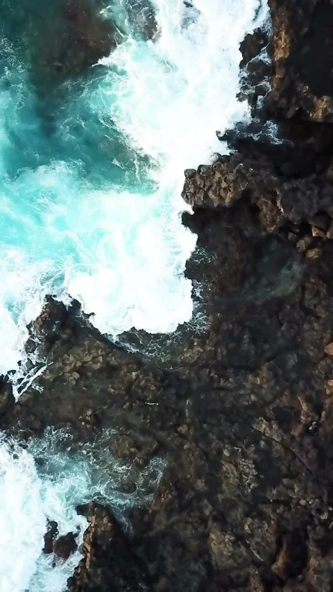 Overhead aerial drone footage capturing powerful turquoise ocean waves crashing Stock Footage 344842147