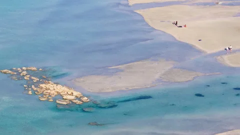 Overhead aerial drone view of pale sandbars and shallow water with people 動画素材 339301544