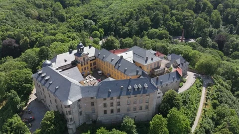 Overhead aerial orbit of Blankenburg castle amid forest 動画素材 337979053