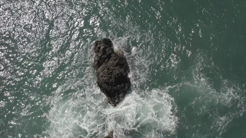 Overhead aerial pulls back over rock formation in the Caribbean Sea off Trinidad Stock-Footage 261912939
