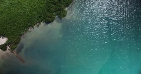 Overhead aerial shot tracking over the water towards the island beach of Cholon 스톡 동영상 72396544