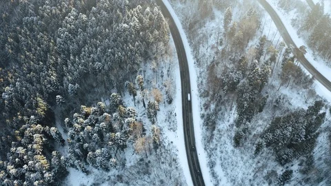 Overhead aerial top view over car travelling on hairpin bend turn road in Stock Footage 102830317
