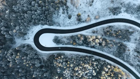 Overhead aerial top view over car travelling on hairpin bend turn road in Stock Footage 102833461